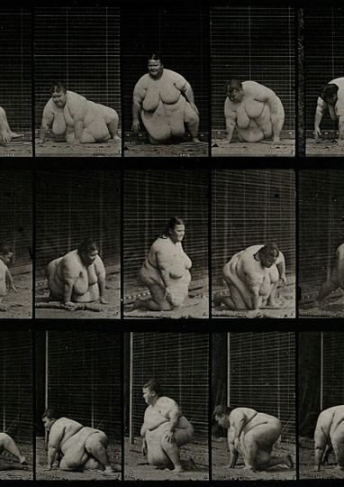 A gargantuan woman getting up off the ground